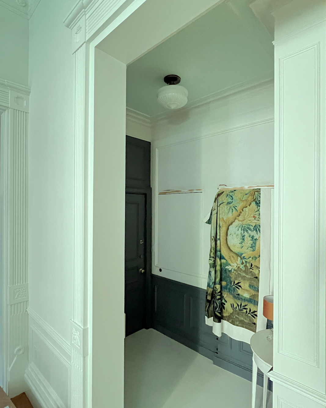 entry with tapestry draped over one jib door