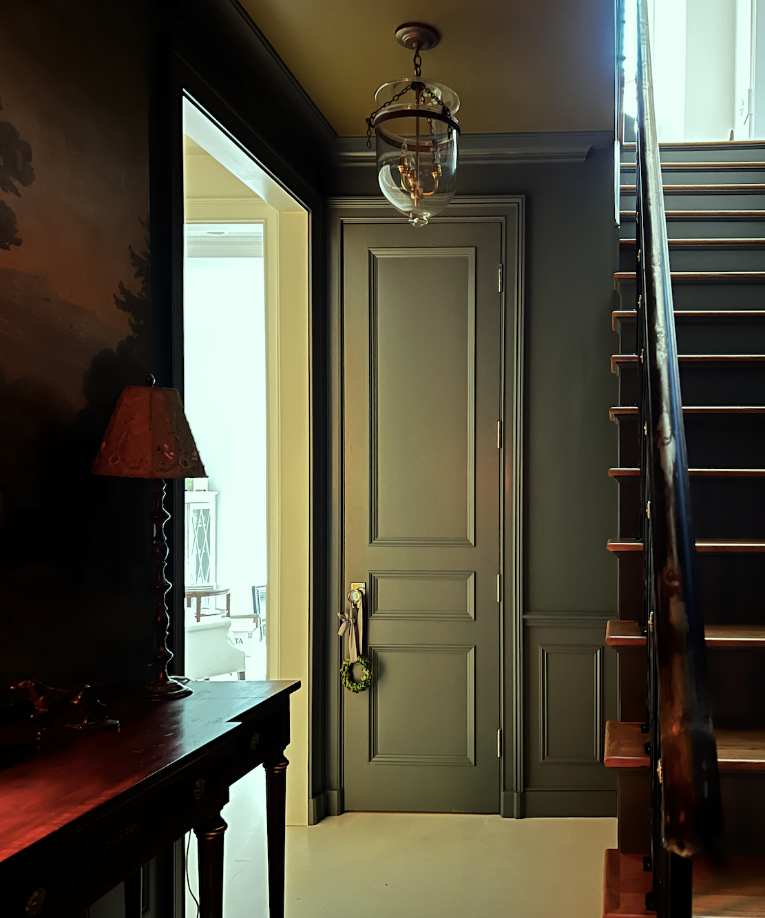 lower entry with 8-foot door + crown moulding + wainscoting